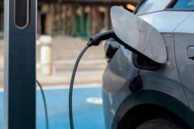 Electric car charging at a station in the city, representing the future of environmentally friendly transportation.