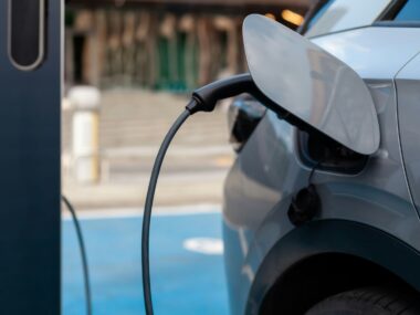 Electric car charging at a station in the city, representing the future of environmentally friendly transportation.