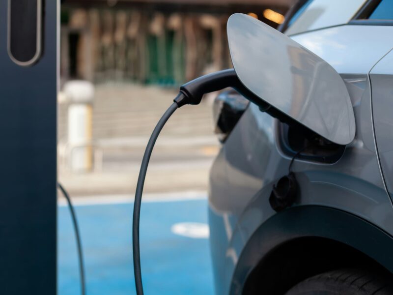 Electric car charging at a station in the city, representing the future of environmentally friendly transportation.