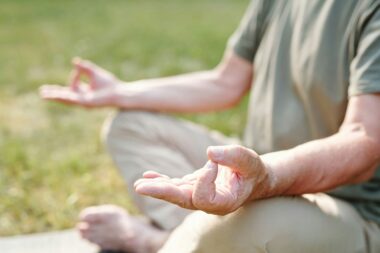 Practicing mindfulness meditation in nature to reduce stress and enhance mental well-being.