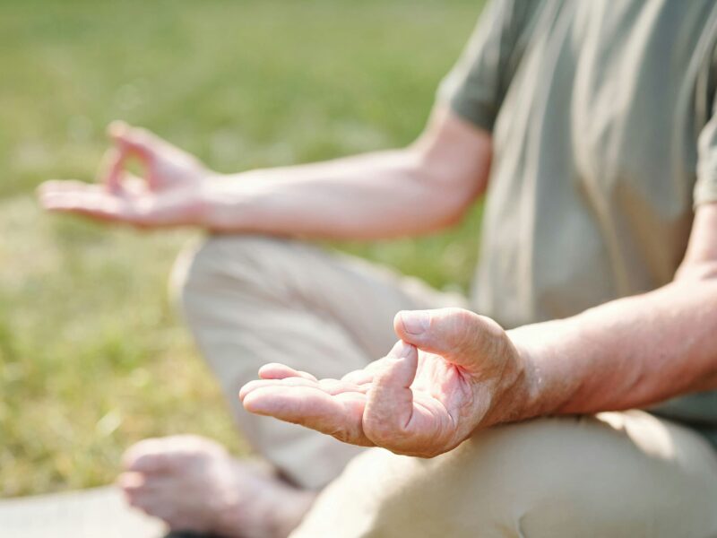 Practicing mindfulness meditation in nature to reduce stress and enhance mental well-being.