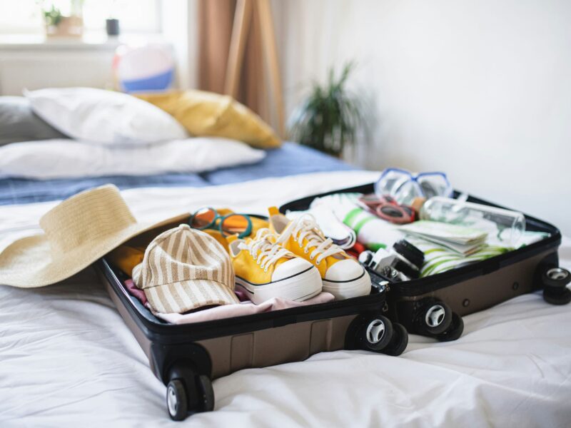 Efficiently packed suitcase with rolled clothes and packing cubes.